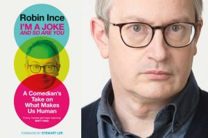 A photo of Robin Ince with the cover of his new book