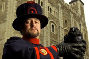Image of author Christopher Skaife in from of the Tower of London with a raven