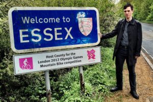 A picture of Tim Burrows next to the Essex county sign