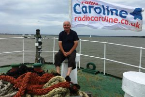 A picture of Ray Clark on the bough of the Radio Caroline ship