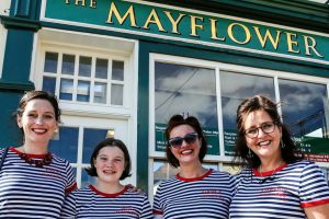 A photo of four Silver Darling singers in front of the Mayflower pub
