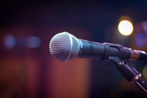 Image of a microphone in a nightclub, ready for a speaker